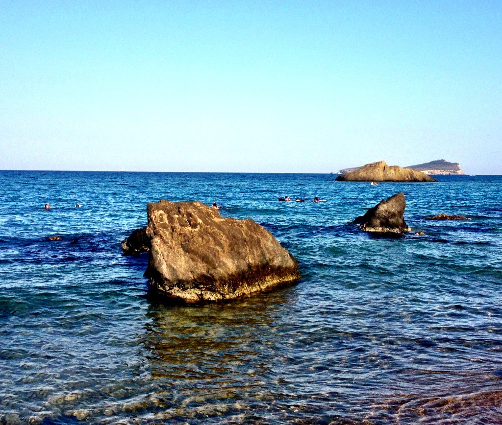rocks surround the cove and provide diving boards in the sea
