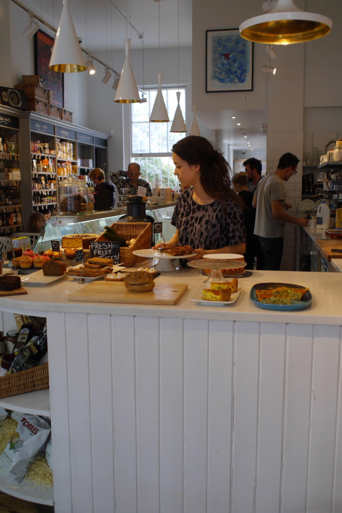 Georgia arranging her goodies at the front of the deli