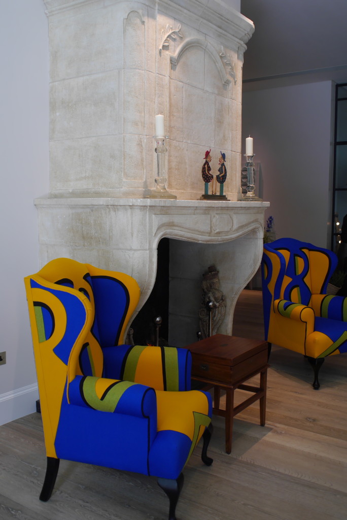 French stone fireplace alongside Kemp's vibrant designs