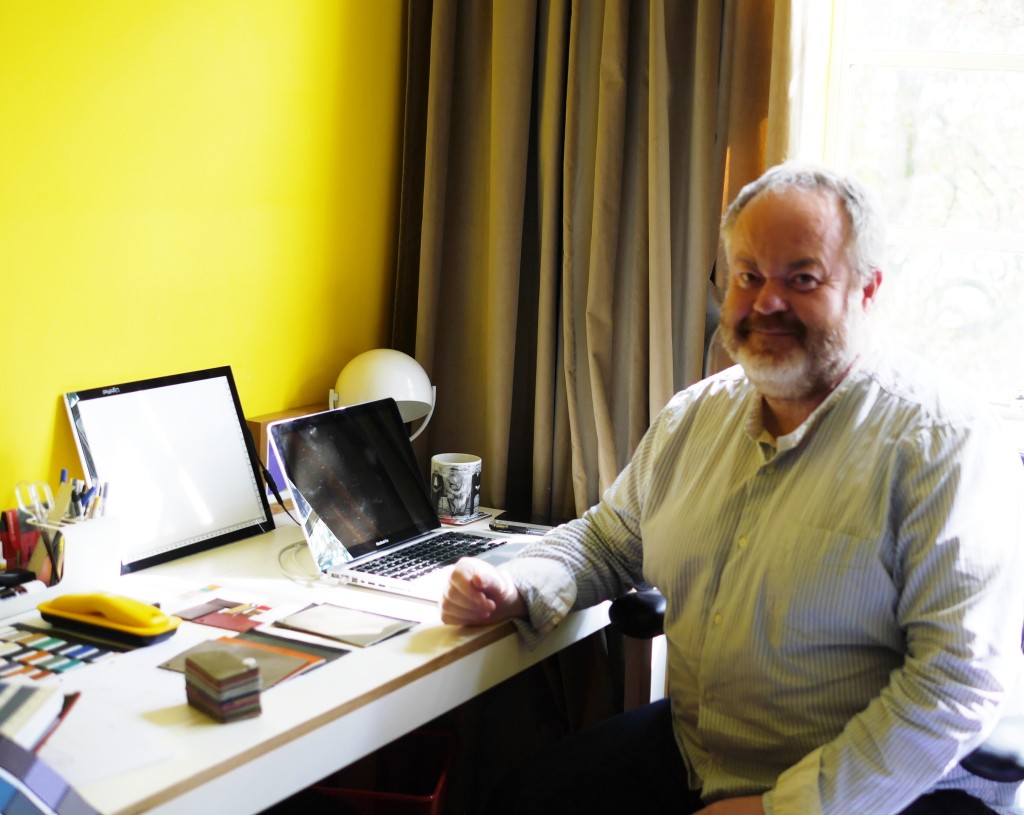 Eddie at his desk (check out his 'sunny' painted walls!)  - this man LOVES colour!